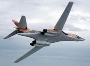  A B-1A flying with its wings swept back, showing its underside