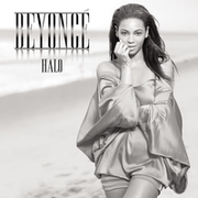 The black and white portrait of a woman. She is standing, her left arm across his body while the other arm rests against her face. She is wearing a metallic short dress. Next to her image, appear the words "Beyoncé" and "Halo" in silver capital letters. Behind them is seen a beach.