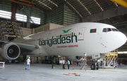 A white aircraft with Bangladesh written along the front side facing right is in a hangar being serviced