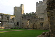 Ruined buildings inside the castle. There is a doorway leading to a ruined room, the kitchen range. In the background is the south-east tower.