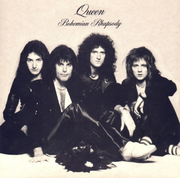 The four members of the band sit together in front of a sandy-coloured background wearing predominantly black clothing. Freddie Mercury appears to be the dominant figure, sat in front of the other three members. From left to right, John Deacon, Mercury, Brian May, Roger Taylor. All four individuals are looking directly at the camera with a neutral expression on their face. Above the band is some black text, printed in an elegant, italic font face. The word "Queen" followed by "Bohemian Rhapsody",  the latter of which is positioned under the band name in the same format yet smaller font.