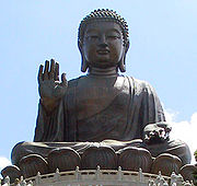 Large bronze statue of Buddha with right hand raised.