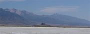 Flat expanse with a mountain range in the distance.