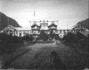 Large half-timbered building with sprawling wings, and an oriental-looking structure on the roof.