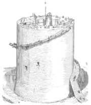 A half finished circular tower with scaffolding near the top. There are holes in the tower and workers on top.