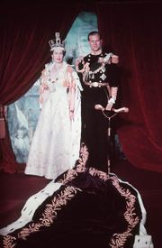 Elizabeth in crown and robes next to her husband in military uniform