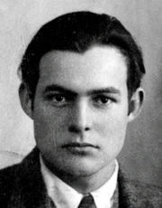 front face view of dark-haired, dark-eyed young man dressed in shirt, tie and jacket