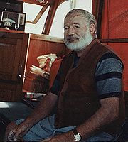 white-haired, white-bearded man with striped shirt