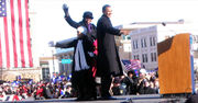 Obama stands on stage with his family. They wave.