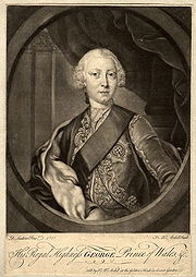 Half-length monochrome portrait of a young clean-shaven man wearing a sash, a finely-embroidered jacket, the star of the  Order of the Garter, and a powdered wig.