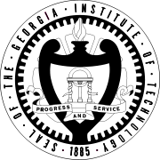 The words "Seal of the Georgia Institute of Technology" encircle a shield, upon which there are three columns under a lintel surmounted by an arch. Above the shield burns a flame. The shield is wrapped in a banner bearing the words "Progress and Service".