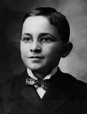 13-year old Caucasian male in suit with bow tie looking forward