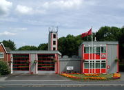 A grey and red, very angular and clean looking prefabricated building of two bays.