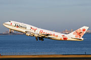 An aircraft taking off from the runway, with a city skyline on the background