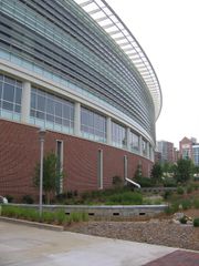 A segment of a curved building constructed from brick, metal and glass