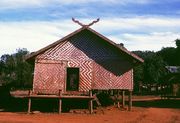 A stilted building with woven walls