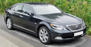 Front quarter view of a sedan parked on a street.