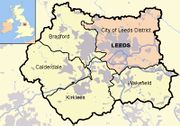 This map shows the locations of Leeds (coloured pink) and the other four metropolitan boroughs of West Yorkshire (clockwise from Leeds: Wakefield, Kirklees, Calderdale and Bradford). County and borough boundaries are black, urban areas grey, motorways blue with white stripe, rivers and bodies of water light blue. An inset shows a map of Great Britain with the location of West Yorkshire highlighted.