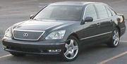 Angled forward view of sedan in a parking lot.