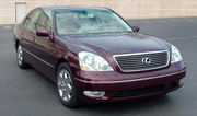 Angled head-on view of sedan in a parking lot.