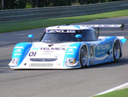 Forward angle view of a racecar on a track; the car is labeled '01', 'Lexus', and 'Telmex'.