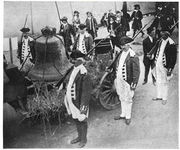 A large bell is seen tied to a wagon.  Soldiers in Revolutionary War uniforms stand by.