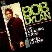 An album cover with a black background. Diagonally aligned, a photo of a man runs across one side of the cover. He is in a brown shirt and looks at the camera, turning the left side of his body towards it. To the right of him are large words printed on the black background, reading: "Bob Dylan", "Like A Rolling Stone", and "Gates of Eden".