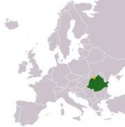 A map of Europe, all in grey, except for one green patch in the lower-right corner, and one small yellow dot on the green