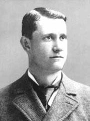 Black and white photo of Ed Delahanty in a suit, facing right