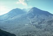 The same volcano and landscape as in the previous picture. Much of the mountain is missing, replaced by an enormous caldera (volcanic crater). The previously forested landscape is now barren as the trees were destroyed in the volcanic blast.