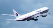 Airliner takeoff. Aft quarter view of jet ascending in the sky, with landing gear in partially retracted position.