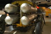 Four silver B28FI nuclear bombs in a rack ready for loading into an aircraft.