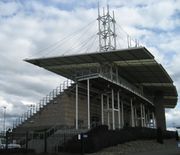 Hillsboro Stadium has a main grandstand built of concrete with a metal roof suspended by cable attached to several towers.