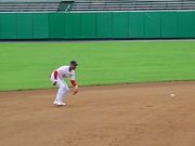 Baseball great is seen fielding a ground ball on a dirt infield