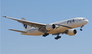 Aircraft landing approach. Front quarter view of twin-engine jet in flight with flaps and landing gear extended.