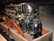 A rear view of an aircraft piston engine shows details of the induction system. The engine is sitting on a bespoke wooden pallet.