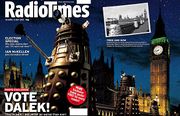 A gatefold magazine cover, depicting a nighttime scene with four gold Daleks in the foreground, the railing of a bridge in the midground, and the Perpendicular Gothic towers of the Houses of Parliament and Big Ben in the background.  The left half of the image contains the text "Radio Times" in the top, and "VOTE DALEK!" in the lower left.  A small black-and-white photograph is superimposed on the upper left of the right side of the image; that photograph, taken from a slightly different angle, shows four Daleks crossing the same bridge, with the same building in the background.