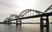 An arch bridge with five arches sits over a river