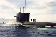 frogmen on the deck of a submarine at sea