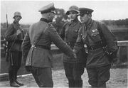 A photo of a German and a Soviet officer shaking hands at the end of the invasion of Poland.