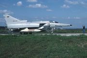 A jet fighter parked on a runway