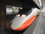 An orange and white high speed train