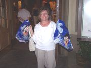 A woman holding shopping bags like a consumer.