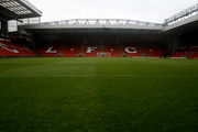 A stand of a football stadium. The seats are red and the words "LFC" are written in white seats.