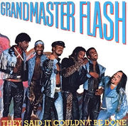 An album cover with seven smiling and laughing men standing in a row and dressed in various styles of denim clothing.