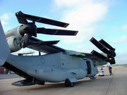  A V-22 with its wing rotated 90 degree so it runs the length of the fuselage.