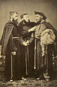 A photograph showing 3 standing men wearing religious habits