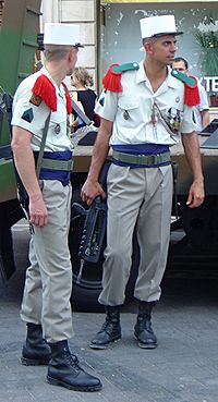 Photograph of two members of the French Foreign Legion dressed in their traditional uniforms.