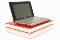 HP 2133 Mini-Note PC netbook with a book