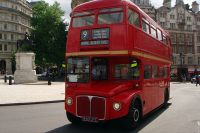 Red two-storey vehicle with windows on each level.